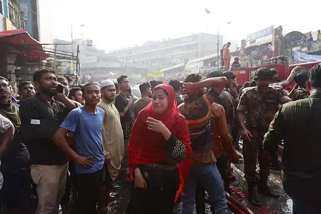 A woman breaks down in tears at the Dhaka New Super Market in the capital on 15 April 2023