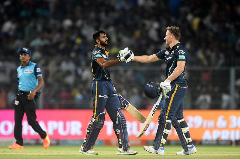 Gujarat Titans' Vijay Shankar (L) and David Miller celebrate after winning the Indian Premier League (IPL) Twenty20 cricket match between Kolkata Knight Riders and Gujarat Titans at the Eden Gardens Stadium in Kolkata on 29 April, 2023