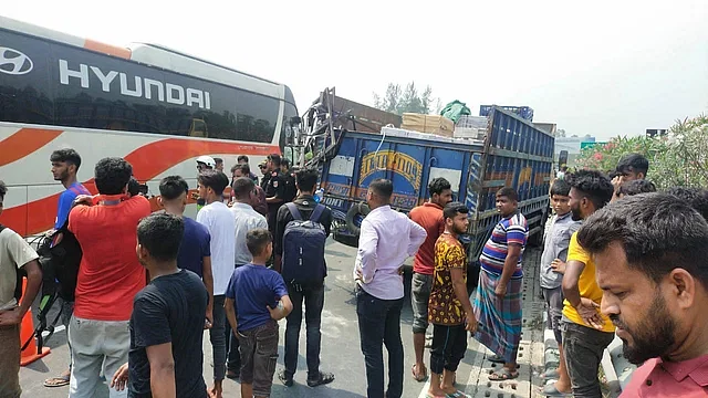 Locals gather after an accident takes place at 8:45 am on Thursday at Shologhor of the Dhaka-Mawa Expressway