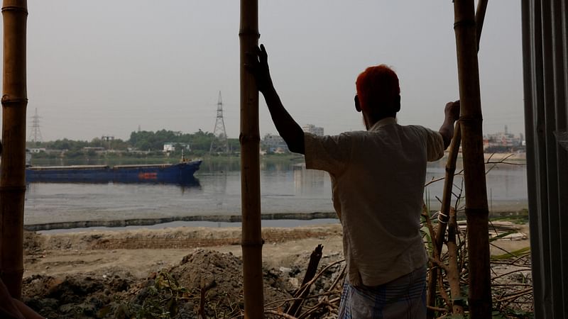 Nurul Islam, 70, looks over the Buriganga river, where he once used to fish in Dhaka, Bangladesh, on 18 March, 2023. Two decades ago Islam earned his living by fishing in the Buriganga river that flows southwest of the Bangladesh capital of Dhaka and was once its lifeline