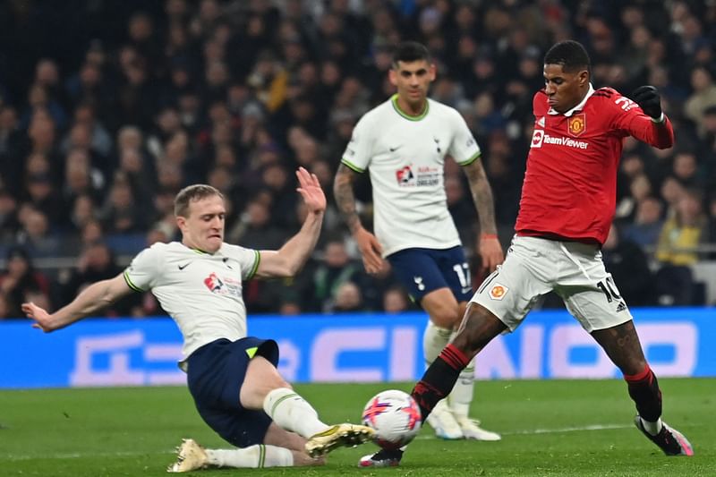 Tottenham Hotspur's English midfielder Oliver Skipp slides in to tackle Manchester United's English striker Marcus Rashford during the English Premier League match between Tottenham Hotspur and Manchester United at Tottenham Hotspur Stadium in London, on 27 April 2023