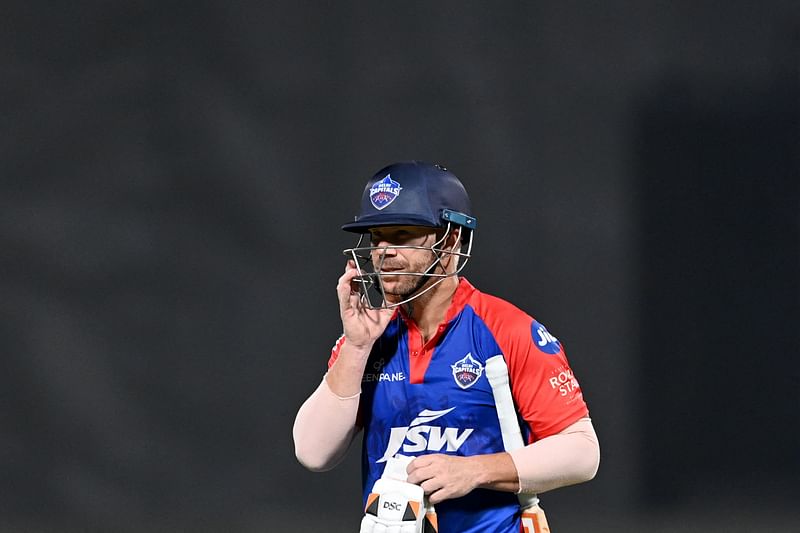 Delhi Capital's David Warner walks back to the pavilion after his dismissal during the Indian Premier League match between Delhi Capitals and Mumbai Indians at the Arun Jaitley Stadium in New Delhi on 11 April 2023