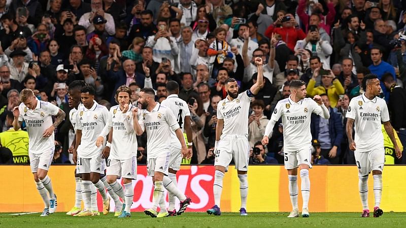 Real Madrid's French forward Karim Benzema (3R) celebrates scoring the opening goal during the UEFA Champions League quarter final first leg football match between Real Madrid CF and Chelsea FC at the Santiago Bernabeu stadium in Madrid on 12 April, 2023