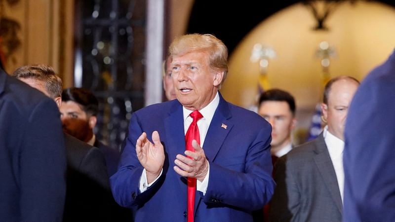 Former US President Donald Trump walks, ahead of delivering remarks on the day of his court appearance in New York after being indicted by a Manhattan grand jury following a probe into hush money paid to porn star Stormy Daniels, in Palm Beach, Florida, US, on 4 April, 2023