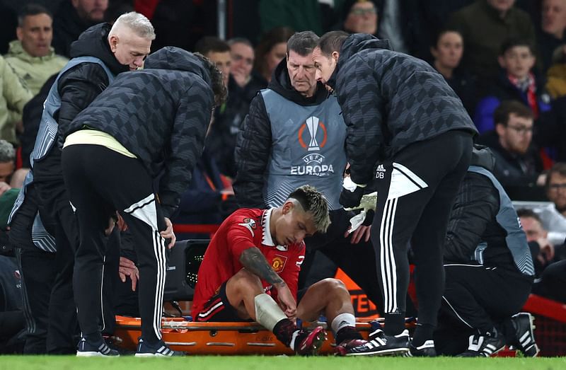 Manchester United's Argentinian defender Lisandro Martinez is stretchered off injured during the UEFA Europa league quarter-final, first leg match between Manchester United and Sevilla at Old Trafford stadium in Manchester, England on 13 April 2023