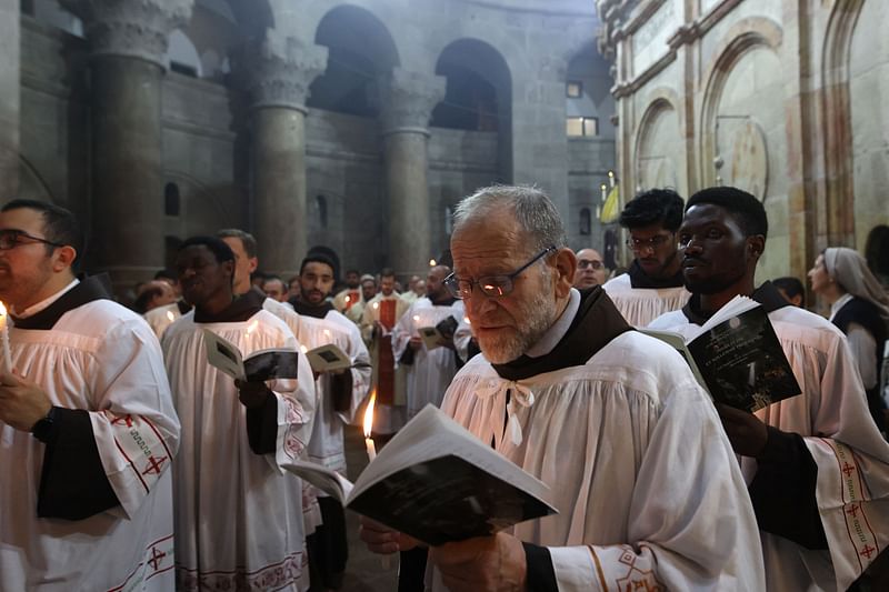 Clergy men attend a mass on Easter Sunday at the Church of the Holy Sepulchre in Jerusalem on April 4, 2023