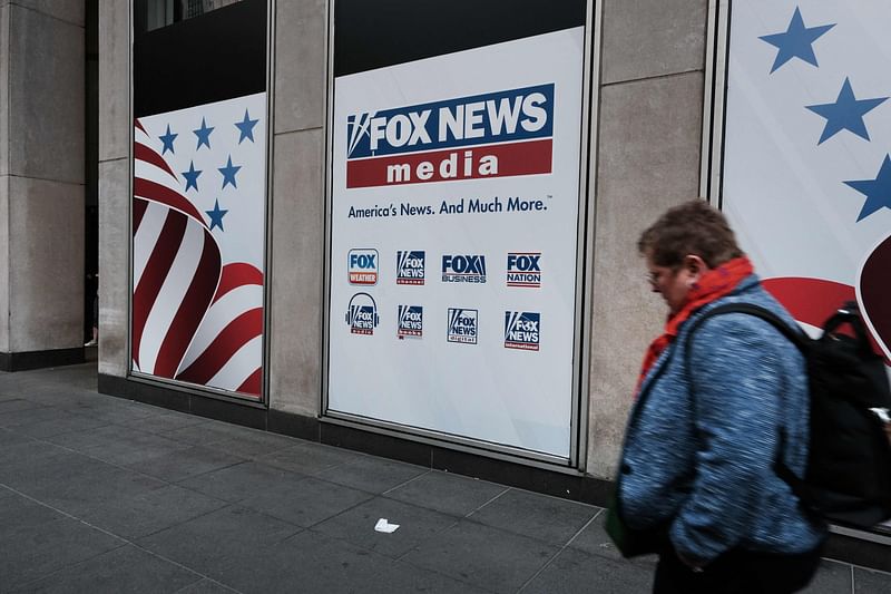 People walk by the News Corporation headquarters, home to Fox News, on April 18, 2023 in New York City