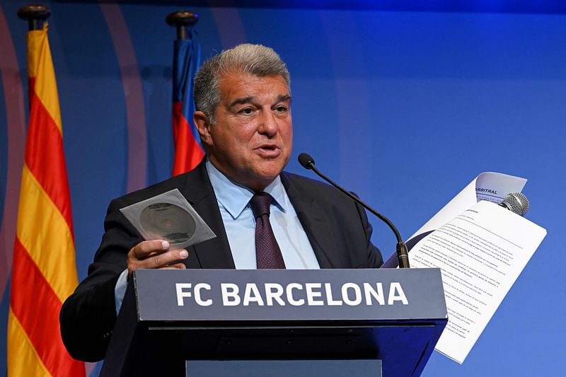 Barcelona's President Joan Laporta presents documents as he addresses a press conference at the Camp Nou stadium in Barcelona on 17 April 2023