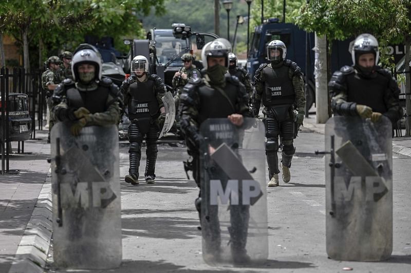 NATO soldiers and International military police secure the area near Zvecan, northern Kosovo on May 30, 2023, a day following clashes with Serb protesters demanding the removal of recently elected Albanian mayors