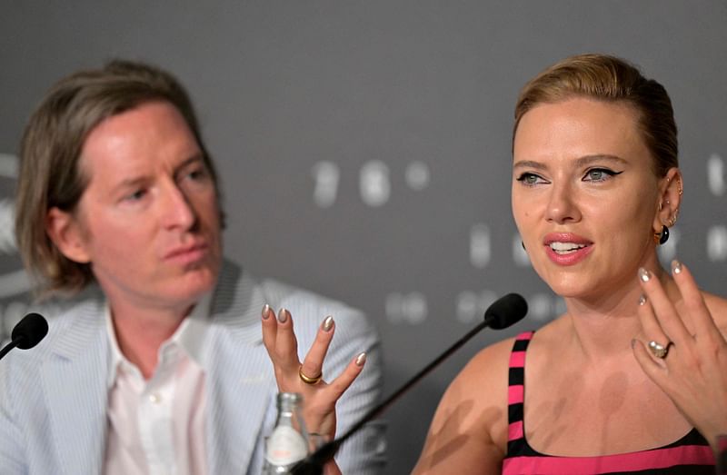 US actress Scarlett Johansson (R) speaks next to US film director Wes Anderson as they attend a press conference for the film 'Asteroid City' during the 76th edition of the Cannes Film Festival in Cannes, southern France, on 24 May, 2023.