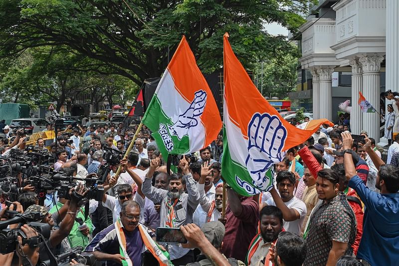 Congress supporters celebrate the party's victory in the Karnataka state legislative assembly election in front of the Karnataka Pradesh Congress Committee (KPCC) office in Bengaluru on May 13, 2023