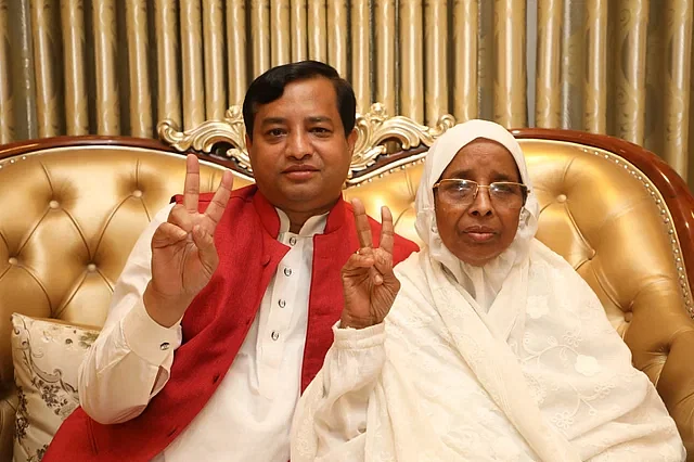 Jayeda Khatun poses with her son Jahangir Alam after being elected as the city mayor of Gazipur