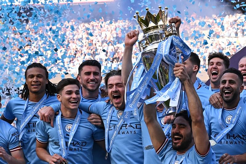 Manchester City's German midfielder Ilkay Gundogan lifts the trophy as Manchester City players celebrate winning the title at the presentation ceremony following the English Premier League match between Manchester City and Chelsea at the Etihad Stadium in Manchester, England on 21 May 2023