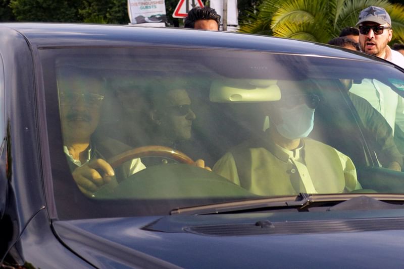 A car carries Pakistan's former Prime Minister Imran Khan, as he arrives to appear before the Supreme Court in Islamabad on 11 May, 2023