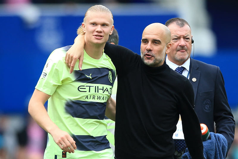 Manchester City's Spanish manager Pep Guardiola with Manchester City's Norwegian striker Erling Haaland