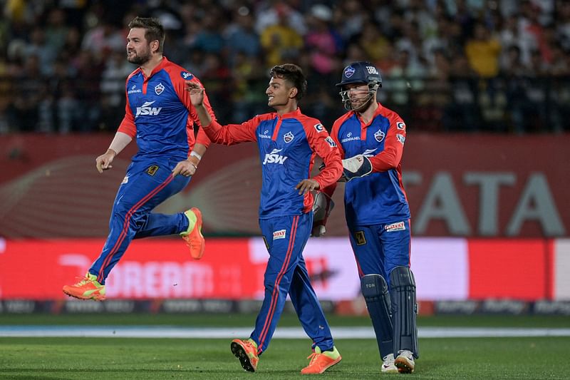 Delhi Capitals' Rilee Rossouw (L) celebrates with teammates after the dismissal of Punjab Kings' Prabhsimran Singh (not pictured) during the Indian Premier League (IPL) Twenty20 cricket match between Punjab Kings and Delhi Capitals at the Himachal Pradesh Cricket Association Stadium in Dharamsala on 17 May, 2023