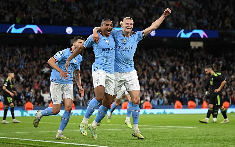 Manchester City's Swiss defender Manuel Akanji (L) celebrates scoring the team's third goal with striker Erling Haaland during the UEFA Champions League second leg semi-final football match against Real Madrid at the Etihad Stadium in Manchester, north west England, on May, 2023