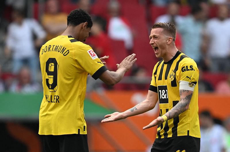 Dortmund's French forward Sebastien Haller celebrates with his teammate Dortmund's German forward Marco Reus after the Bundesliga match between FC Augsburg and BVB Borussia Dortmund in Augsburg, Germany on 21 May 2023