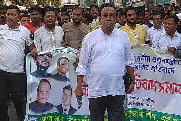 Mustafizur Rahaman Chowdhury was seen taking part in a procession and carrying arms openly.