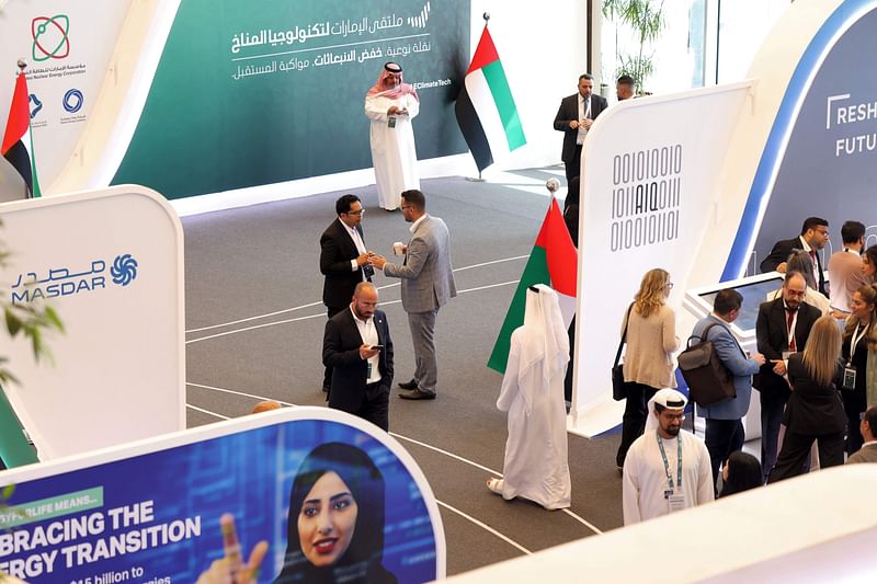 In this picture taken on May 10, 2023, people attend the UAE Climate Tech Forum in Abu Dhabi. Faced with mounting pressure over planet-heating pollution, the Arab Gulf's energy giants are turning to humble tech start-ups as they search for ways to remove emissions while keeping oil flowing