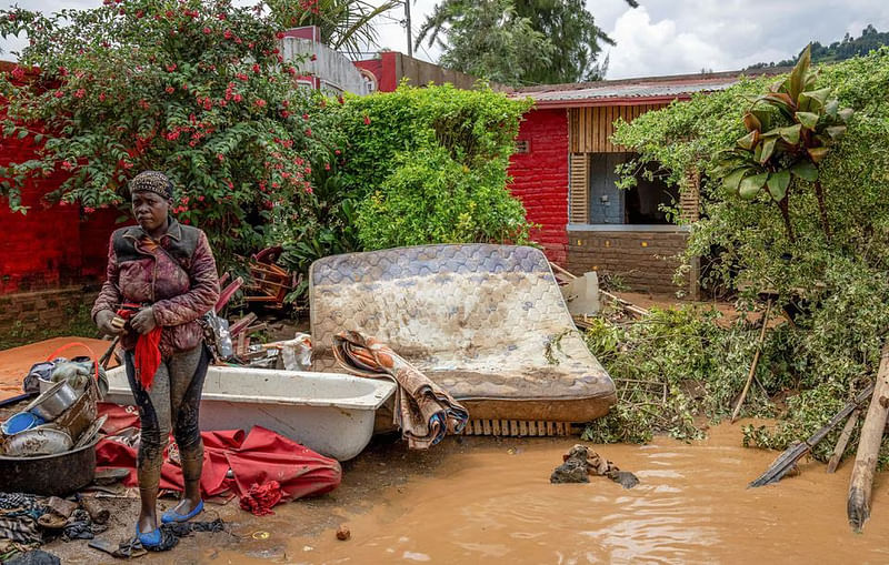 A resident salvages her household items washed away following rains that triggered flooding and landslides in Rubavu district, Western province, Rwanda on 3 May, 2023.