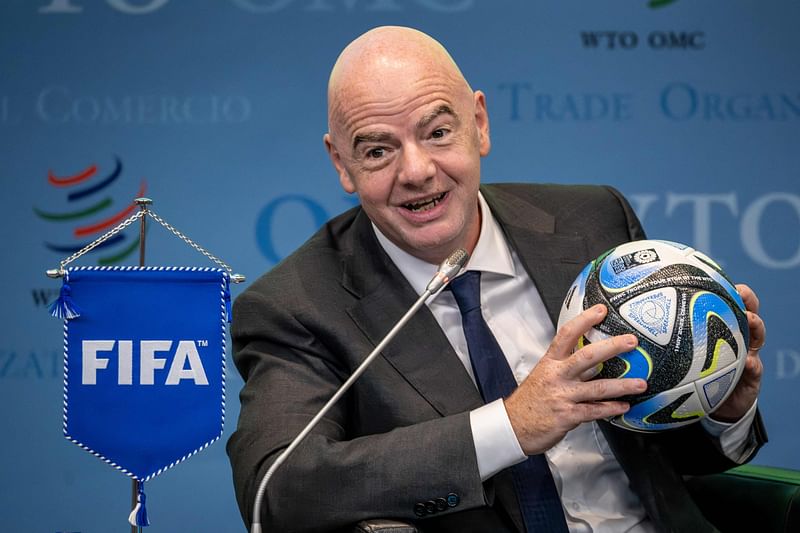 FIFA President Gianni Infantino holds an official ball of the 2023 FIFA Women's World Cup during the "Making trade score for women!" discussion on the use of football as a tool for trade and development at the WTO headquarters in Geneva on 1 May 2023