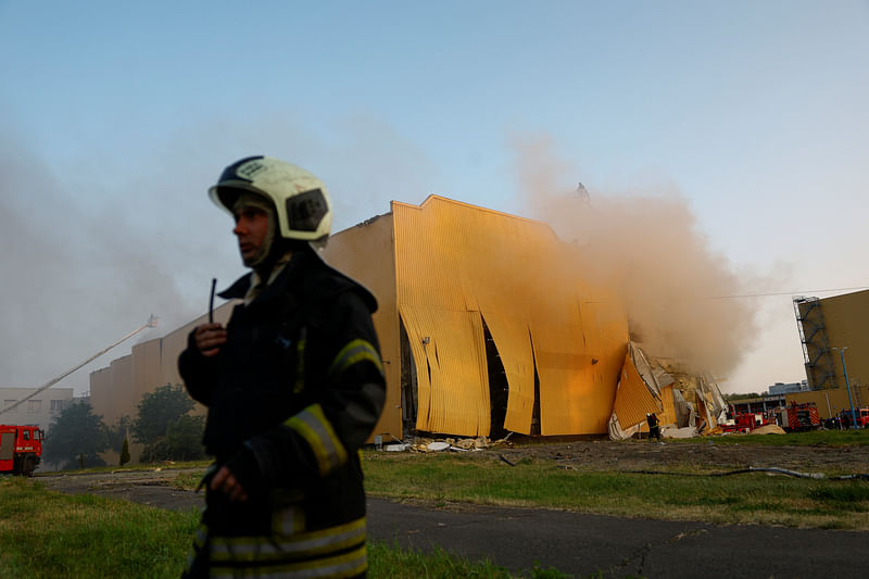 A firefighter works at a site of a tobacco factory damaged during Russian suicide drone strike, amid Russia's attack on Ukraine, in Kyiv, Ukraine May 28, 2023