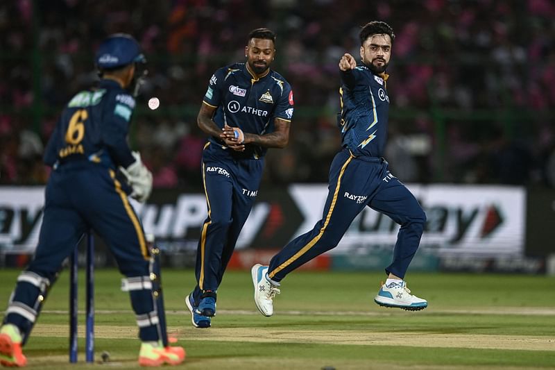 Gujarat Titans' Rashid Khan celebrates with teammates after taking the wicket of Rajasthan Royals' Ravichandran Ashwin during the Indian Premier League match between Rajasthan Royals and Gujarat Titans at the Sawai Mansingh Stadium in Jaipur on 5 May 
 2023