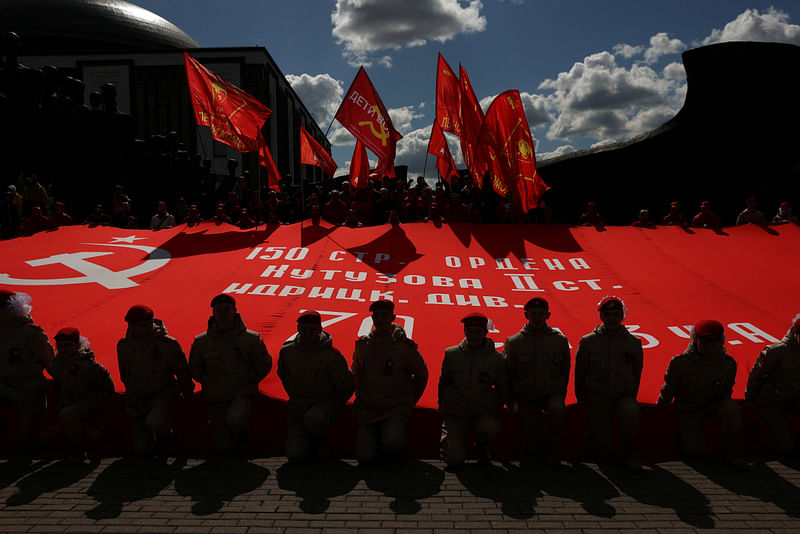 Members of the Youth Army movement hold a large copy of the Soviet Banner of Victory during a gathering of members and supporters of the Russian Communist Party on the eve of Victory Day, marking the anniversary of the victory over Nazi Germany in World War Two, in Moscow, Russia May 8, 2023