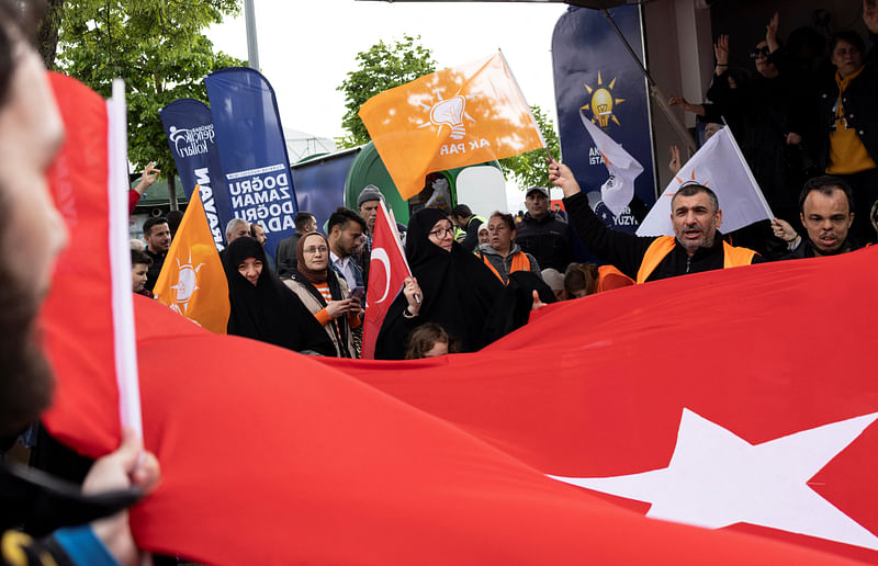 Supporters of Turkish President Tayyip Erdogan wave national and AK Party flags during a campaign event ahead of the 14 May presidential and parliamentary elections, in Istanbul, Turkey 9 May, 2023