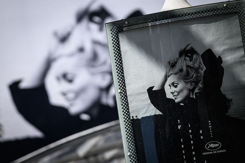 This photograph shows the official poster of the 76th Cannes Film Festival featuring a photograph of actress Catherine Deneuve by Jack Garofalo, in front of the Palais des Festivals in Cannes, southeastern France, on 15 May, 2023. Cannes Film festival will take place from 15 May to 27 May, 2023.