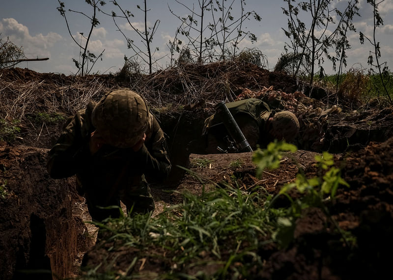 Ukrainian service members from a 28th separate mechanised brigade named after the Knights of the Winter Campaign of the Armed Forces of Ukraine, fire a mortar at their positions at a front line, amid Russia's attack on Ukraine, near the city of Bakhmut in Donetsk region, Ukraine May 18, 2023