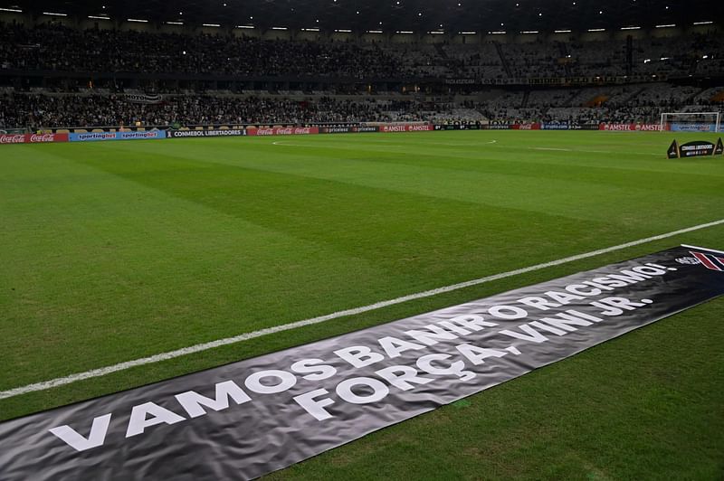 banner against racism and in support of Real Madrid's Brazilian player Vinicius Junior, who was the target of persistent racist abuse during his team's 1-0 defeat to Valencia earlier this week during the Spanish La Liga tournament, is displayed before the Copa Libertadores group stage second leg football match between Brazil's Atletico Mineiro and Brazil's Athletico Paranaense at Mineirao Stadium in Belo Horizonte, Brazil, on 23 May, 2023