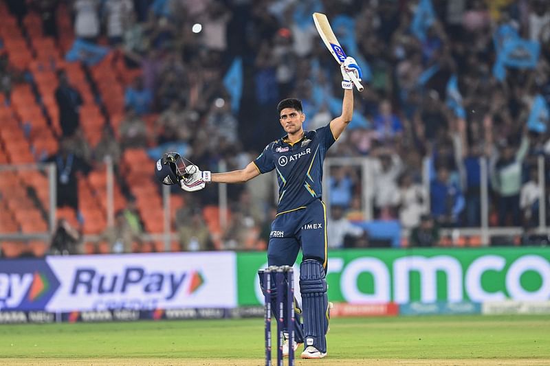 Gujarat Titans' Shubman Gill raises his bat to celebrates scoring a century (100 runs) during the Indian Premier League (IPL) Twenty20 second qualifier cricket match between Mumbai Indians and Gujarat Titans at the Narendra Modi Stadium in Ahmedabad on May 26, 2023