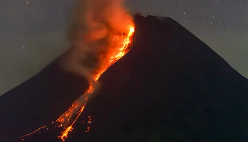 Mount Merapi volcano spews lava from its crater as seen from Sleman in Yogyakarta early on 18 March, 2023