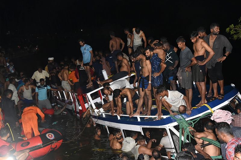 In this photograph taken on 7 May, 2023, people carry out rescue operation at the site of a boat accident in Tanur, in Malappuram district of India’s Kerala state