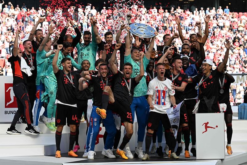 Bayern Munich's players celebrate with the trophy after the German first division Bundesliga football match between FC Cologne and FC Bayern Munich in Cologne, western Germany on 27 May, 2023