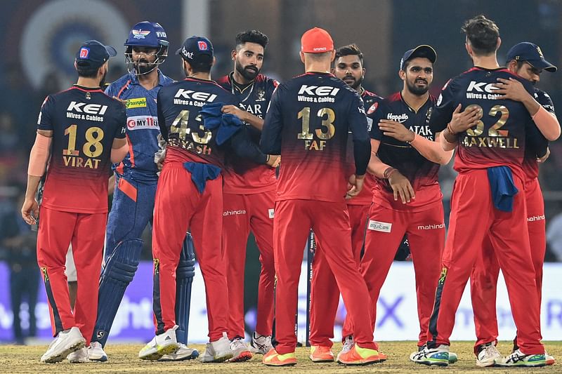 Lucknow Super Giants' KL Rahul (2L) greets Royal Challengers Bangalore's players at the end of the Indian Premier League (IPL) Twenty20 cricket match between Lucknow Super Giants and Royal Challengers Bangalore at the Ekana Cricket Stadium in Lucknow on 1 May, 2023