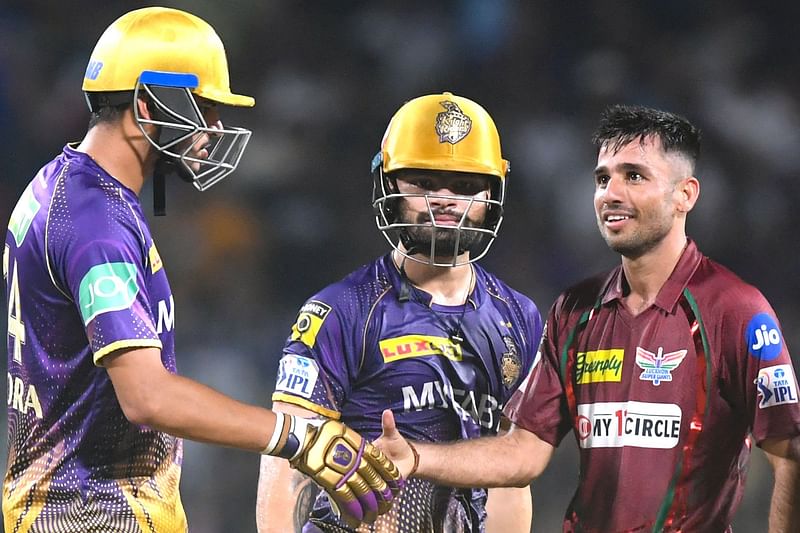 Kolkata Knight Riders' Rinku Singh looks on as Lucknow Super Giants' Ravi Bishnoi celebrates after winning the Indian Premier League match between Lucknow Super Giants and Kolkata Knight Riders at the Eden Gardens Stadium in Kolkata on 20 May 2023