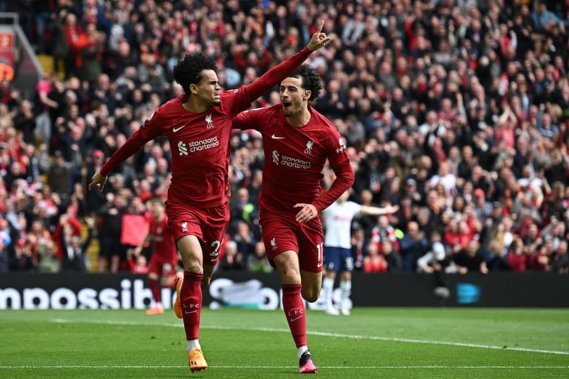 Liverpool's Colombian midfielder Luis Diaz (L) celebrates with Liverpool's English midfielder Curtis Jones (R) after scoring their second goal during the English Premier League football match between Liverpool and Tottenham Hotspur at Anfield in Liverpool, north west England on 30 April, 2023