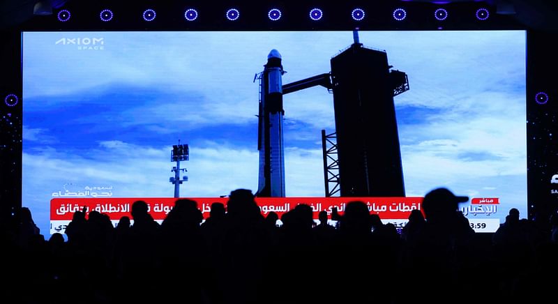 People watch a screen in Riyadh on 21 May, 2023 as a SpaceX Falcon 9 rocket carrying the Axiom Mission 2 astronauts prepares to lift off from pad 39A at NASA's Kennedy Space Center in Florida