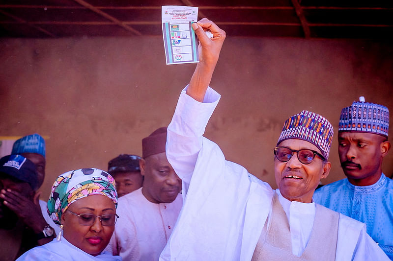 Nigerian President Muhammadu Buhari and his wife Aisha Buhari arrive to cast their votes during presidential election at a polling station in Daura, Nigeria, 25 February 2023