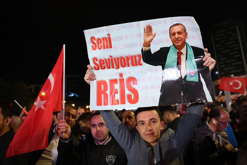 Supporter of Turkish president Tayyip Erdogan holds a poster which reads "We Love You Chief" outside the AK Party headquarters after polls closed in Turkey's presidental and parliamentary elections in Ankara, Turkey May 15, 2023