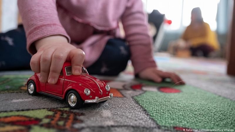 A child plays with a toy car