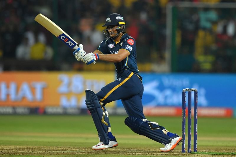 Gujarat Titans' Shubman Gill watches the ball after playing a shot during the Indian Premier League (IPL) Twenty20 cricket match between Royal Challengers Bangalore and Gujarat Titans at the M Chinnaswamy Stadium in Bengaluru on 21 May, 2023