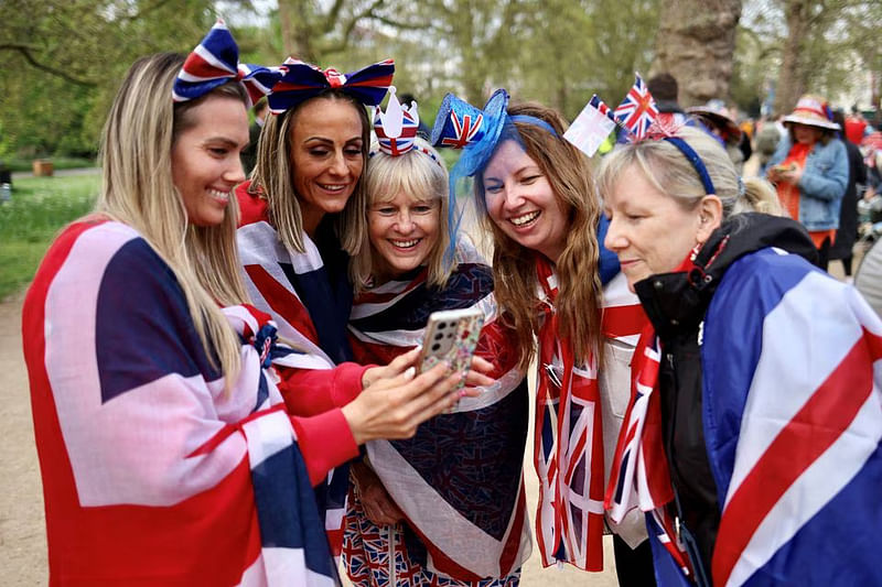 A group of friends and family from Thurrock watch a social media video on The Mall, ahead of the coronation of Britain's King Charles and Camilla, Queen Consort, in London, Britain on 5 May, 2023.