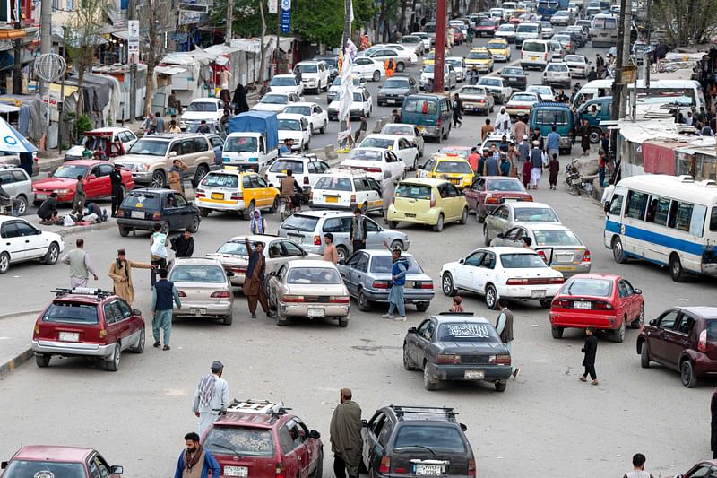 This photograph taken on April 25, 2023, shows Toyota Corolla cars in a traffic jam beneath the kot-e Sangi bridge in Kabul. Little is certain in Afghanistan -- armies invade and retreat, governments rise and fall -- but when the key of a Toyota Corolla turns in the ignition, the engine can be relied upon to roar to life