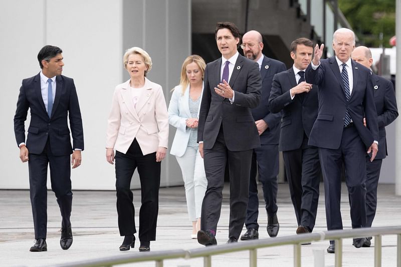 Britain's Prime Minister Rishi Sunak, European Commission President Ursula von der Leyen, Italy's Prime Minister Giorgia Meloni, Canada's Prime Minister Justin Trudeau, President of the European Council Charles Michel, France's President Emmanuel Macron, US President Joe Biden and Germany's Chancellor Olaf Scholz walk in the Peace Memorial Park as part of the G7 Leaders' Summit in Hiroshima on 19 May, 2023.