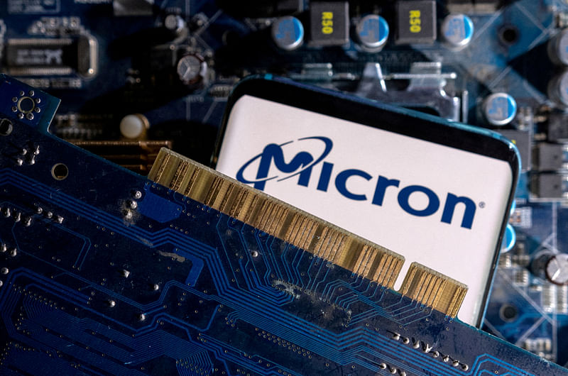 A smartphone with a displayed Micron logo is placed on a computer motherboard in this illustration taken on 6 March, 2023