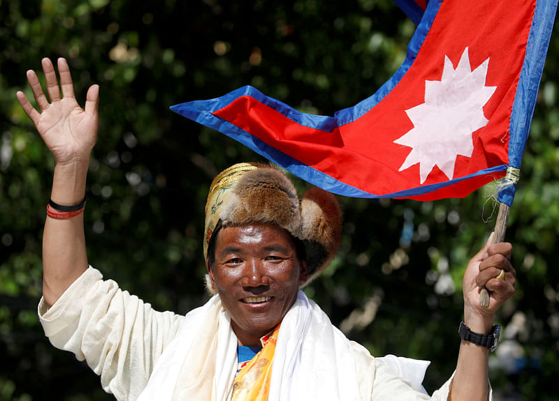 Nepali mountaineer Kami Rita Sherpa waves upon his arrival after climbing Mount Everest for the 24th time in 2019